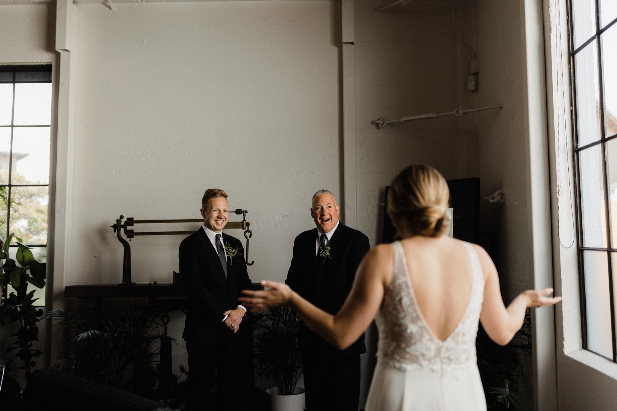 bride doing a first look with her dad and bother 