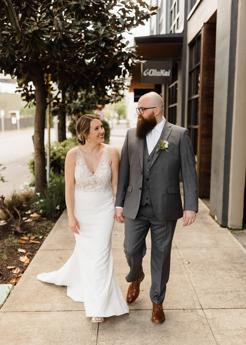 bride and groom walking down the street in Portland Oregon 