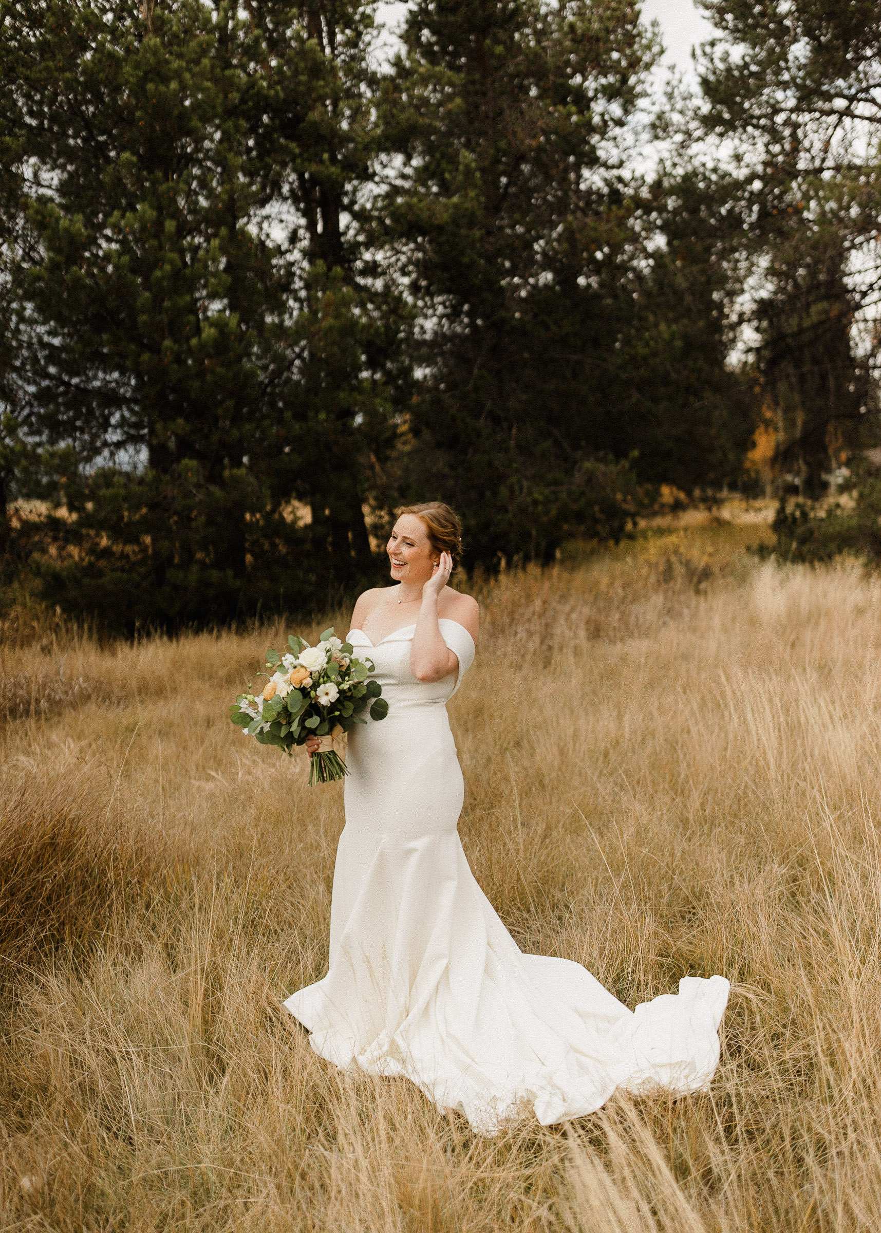 Bride poses for portraits in a field at Sunriver Resort