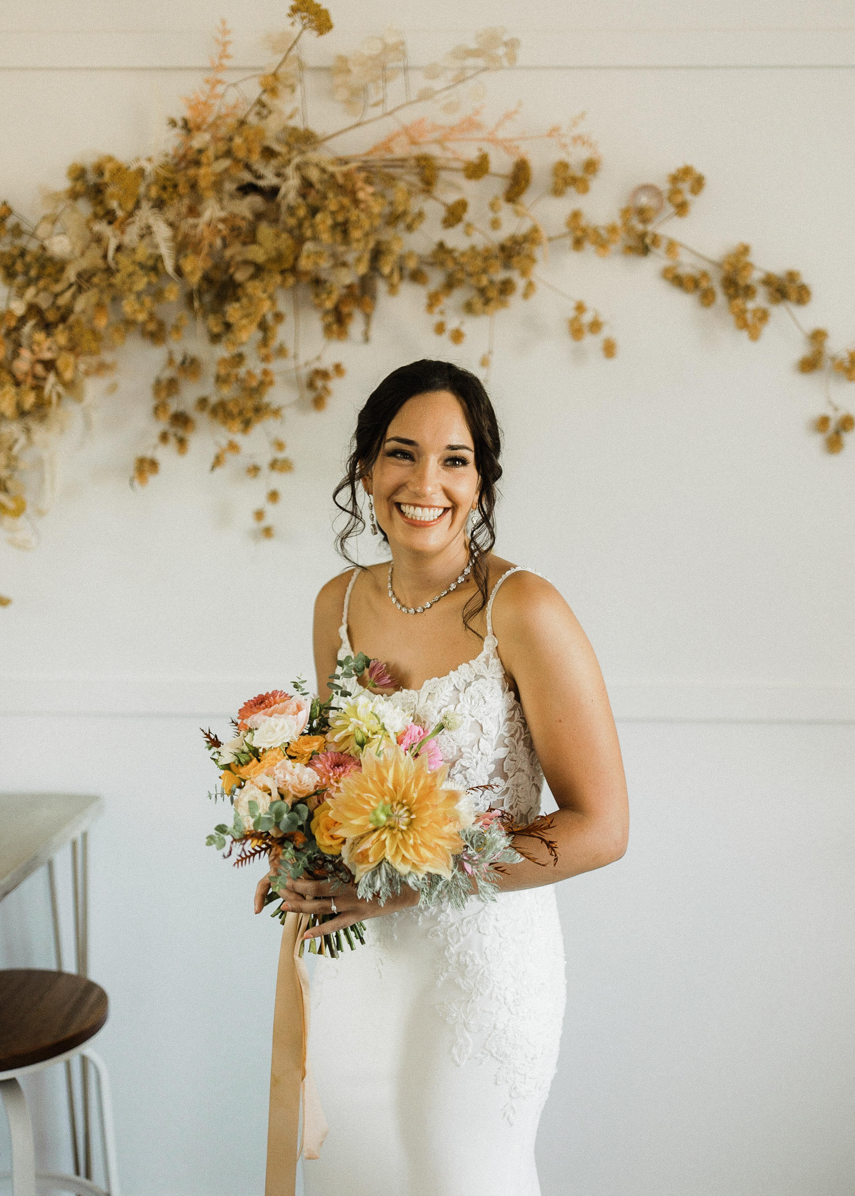 Bride smiles for a portrait in a bridal suite 