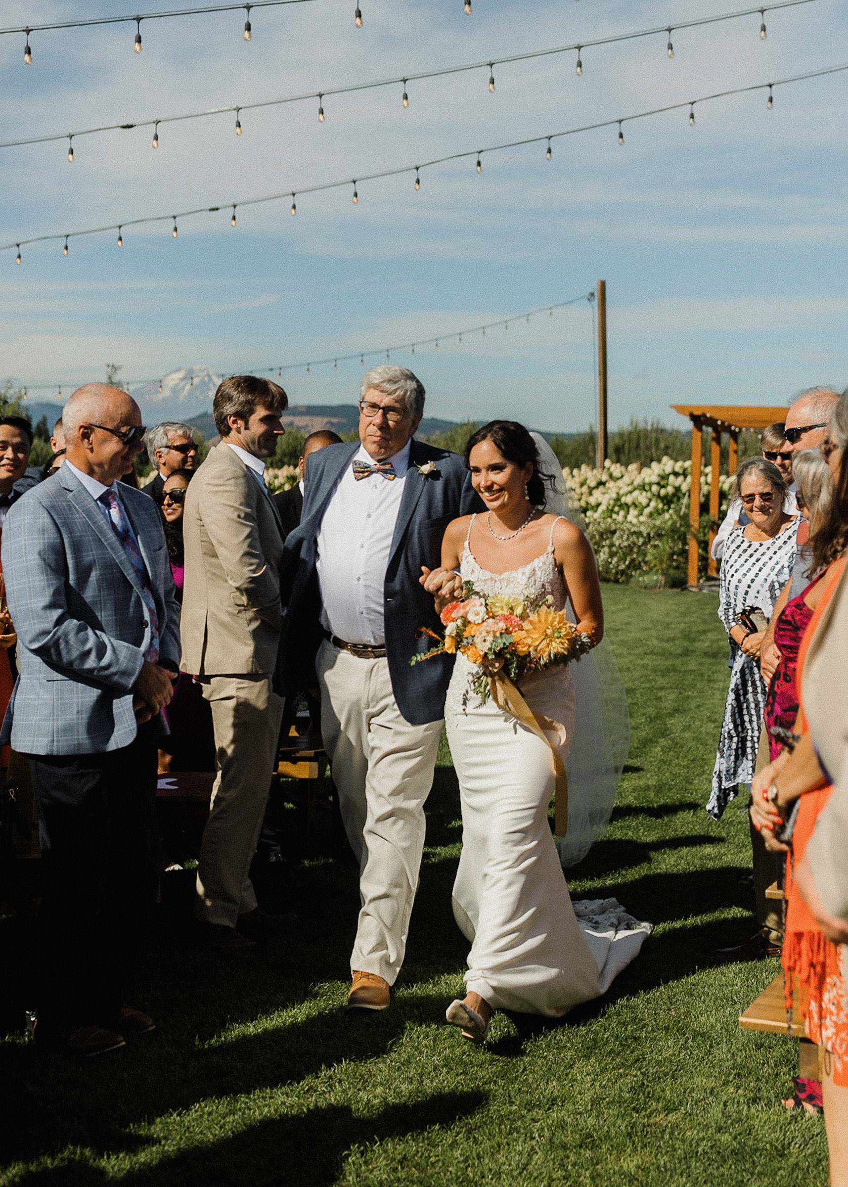 Father walks bride down the aisle during a wedding ceremony at The Orchard in Hood River