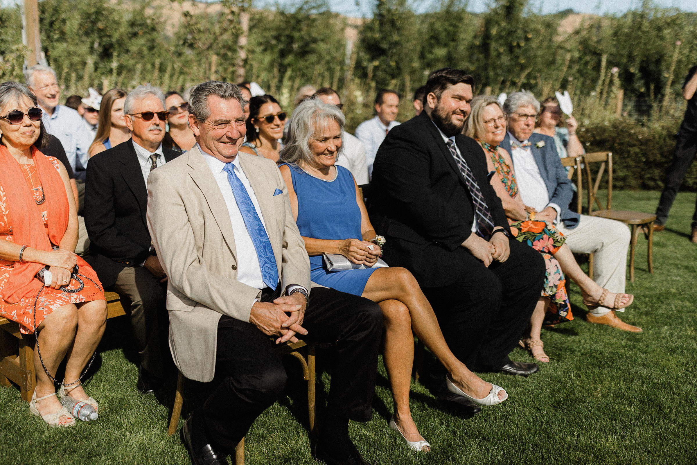 Guests smile during wedding ceremony