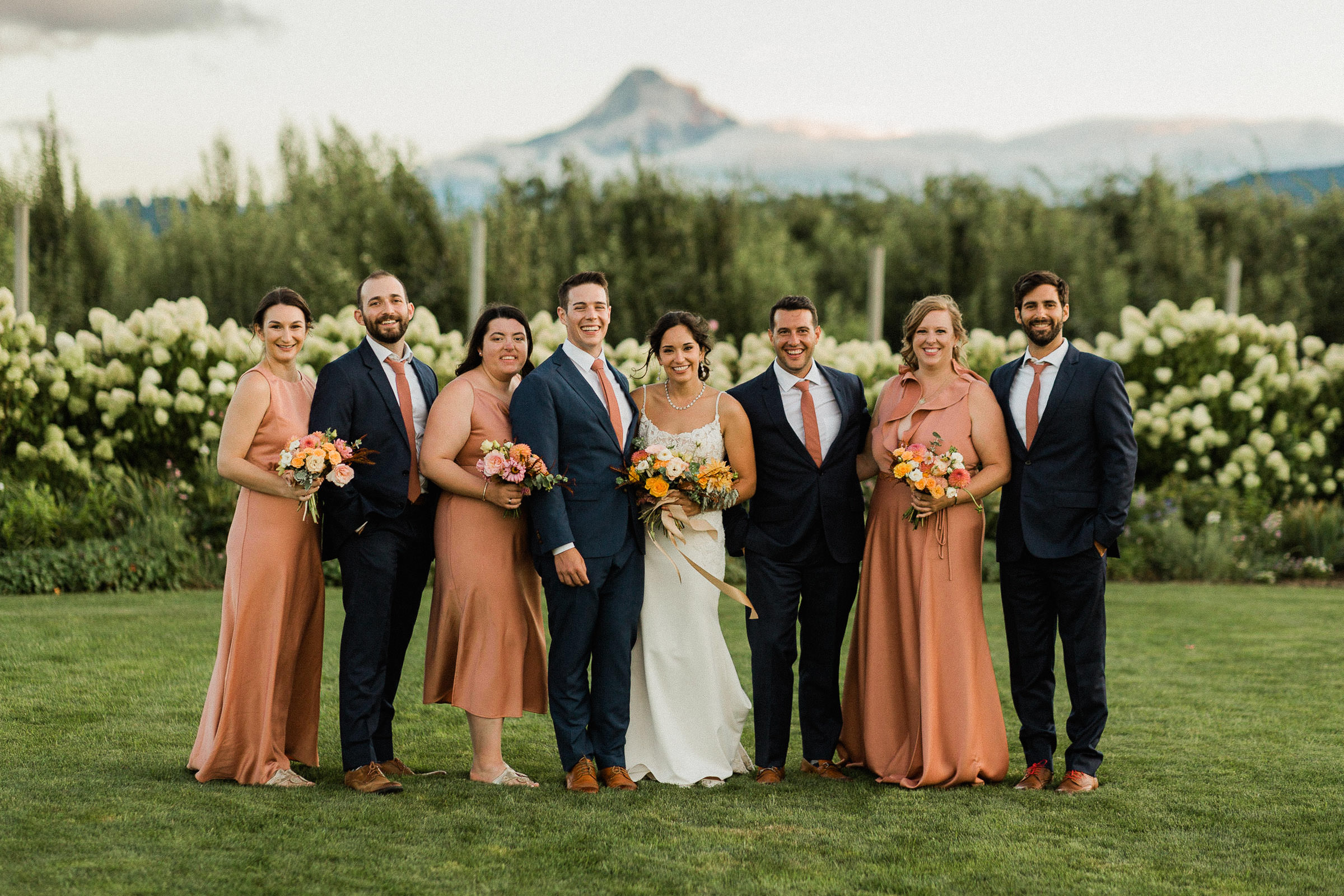 Wedding party poses at The Orchard with a view of Mount Hood