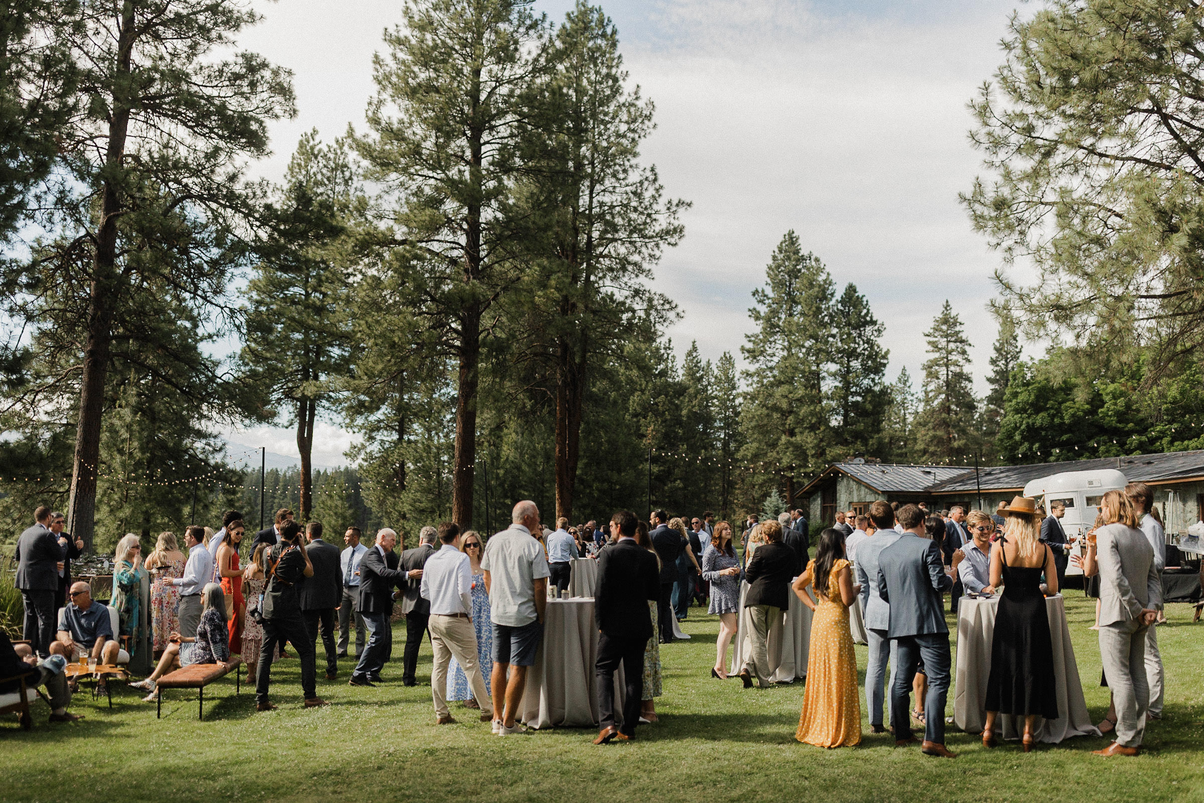 A wide view of the cocktail hour on the lawn outside House on the Metolius
