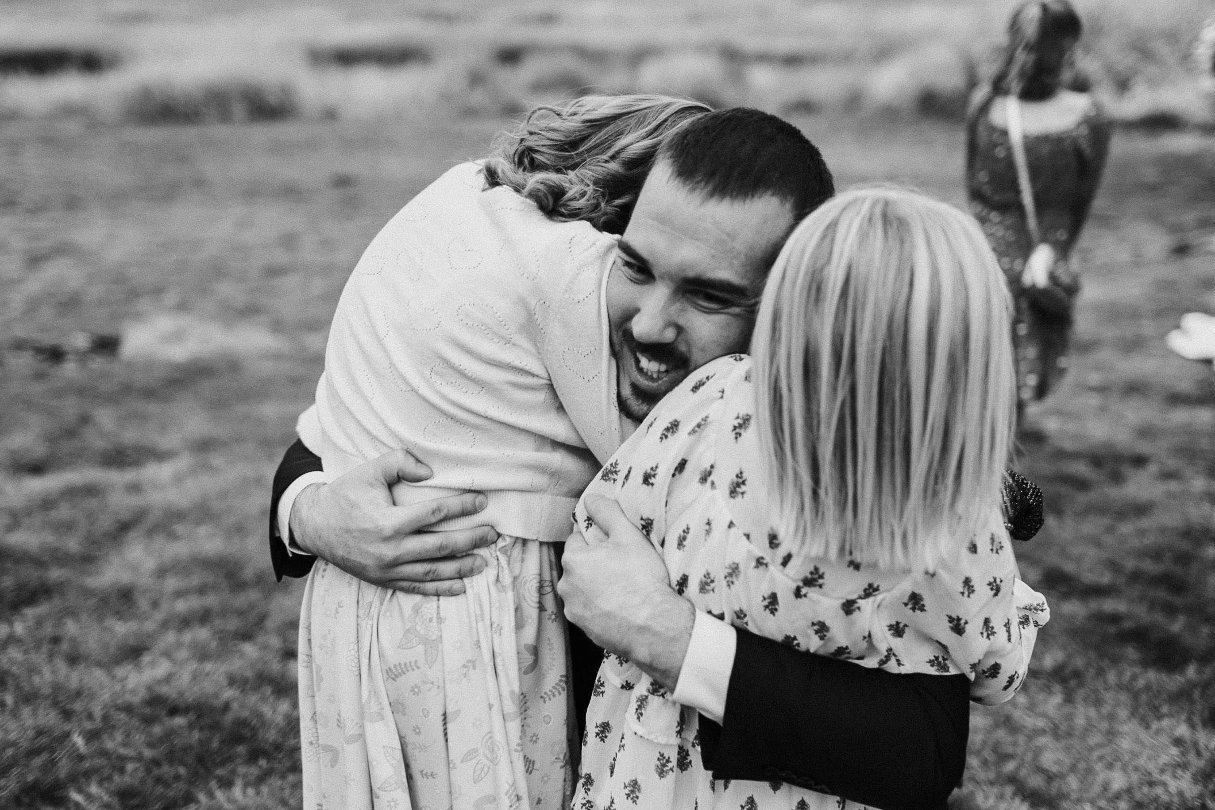 Groom hugs his young nieces