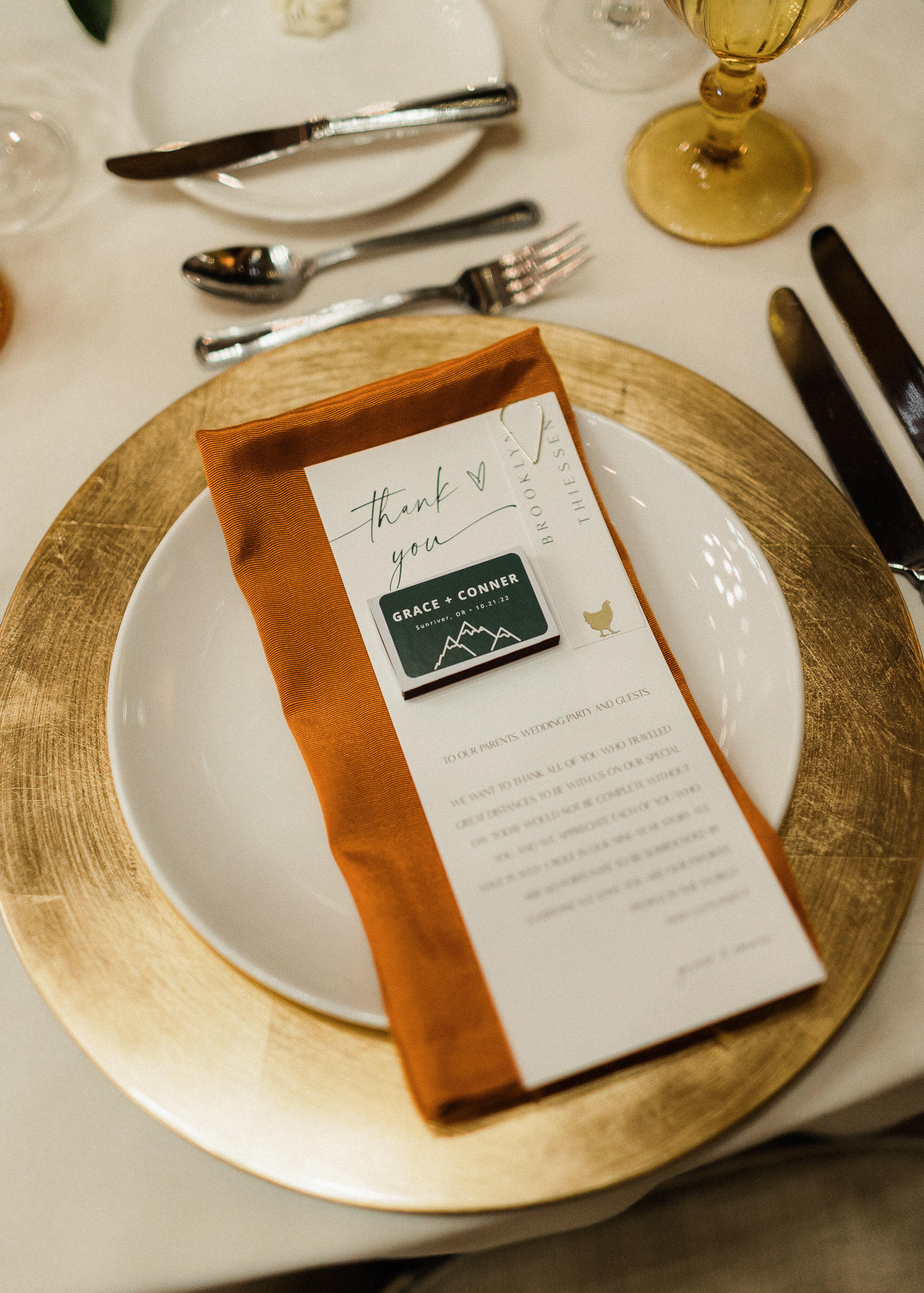 Wedding reception table settings including menus and custom matchboxes