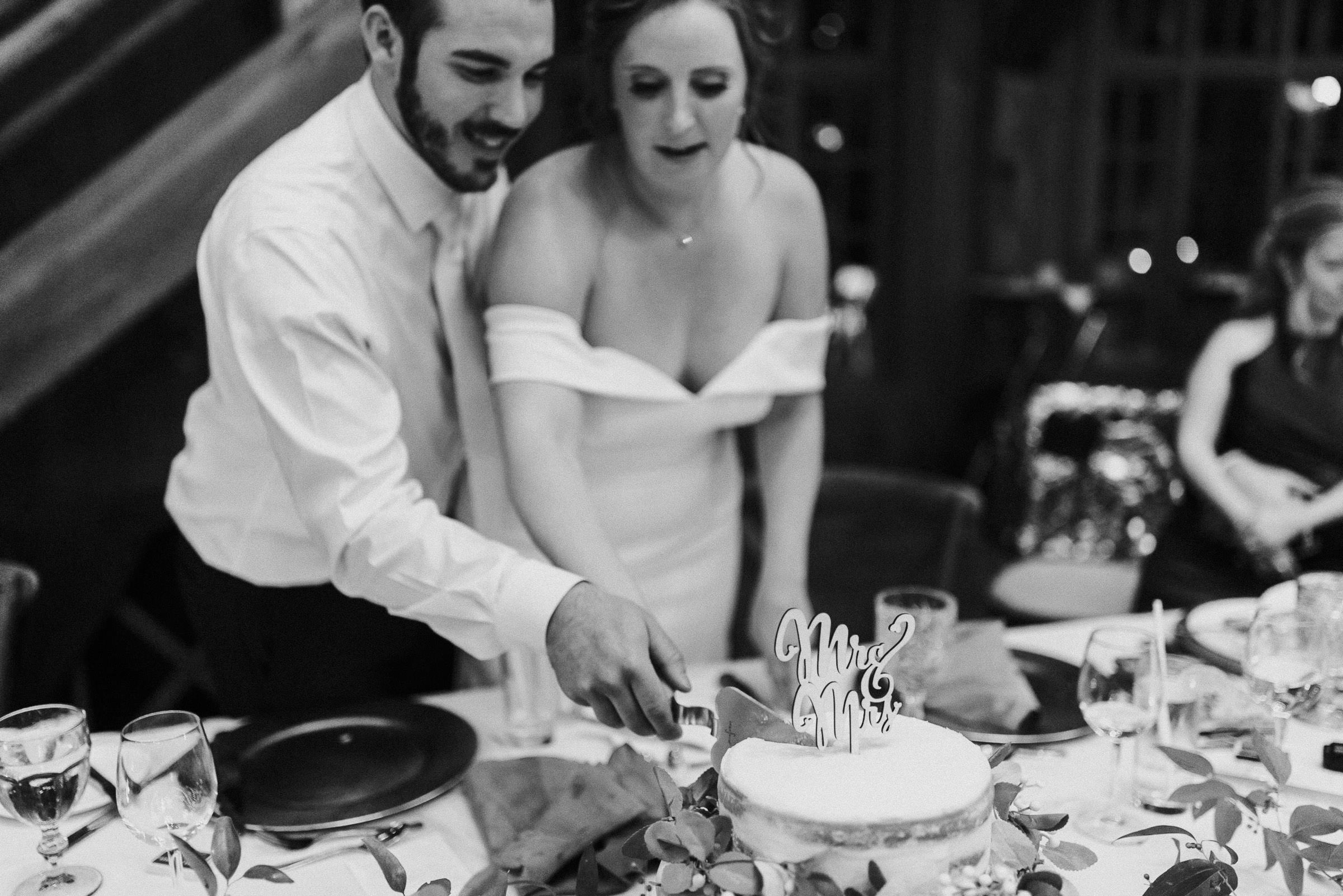 Bride and groom cut their cake together