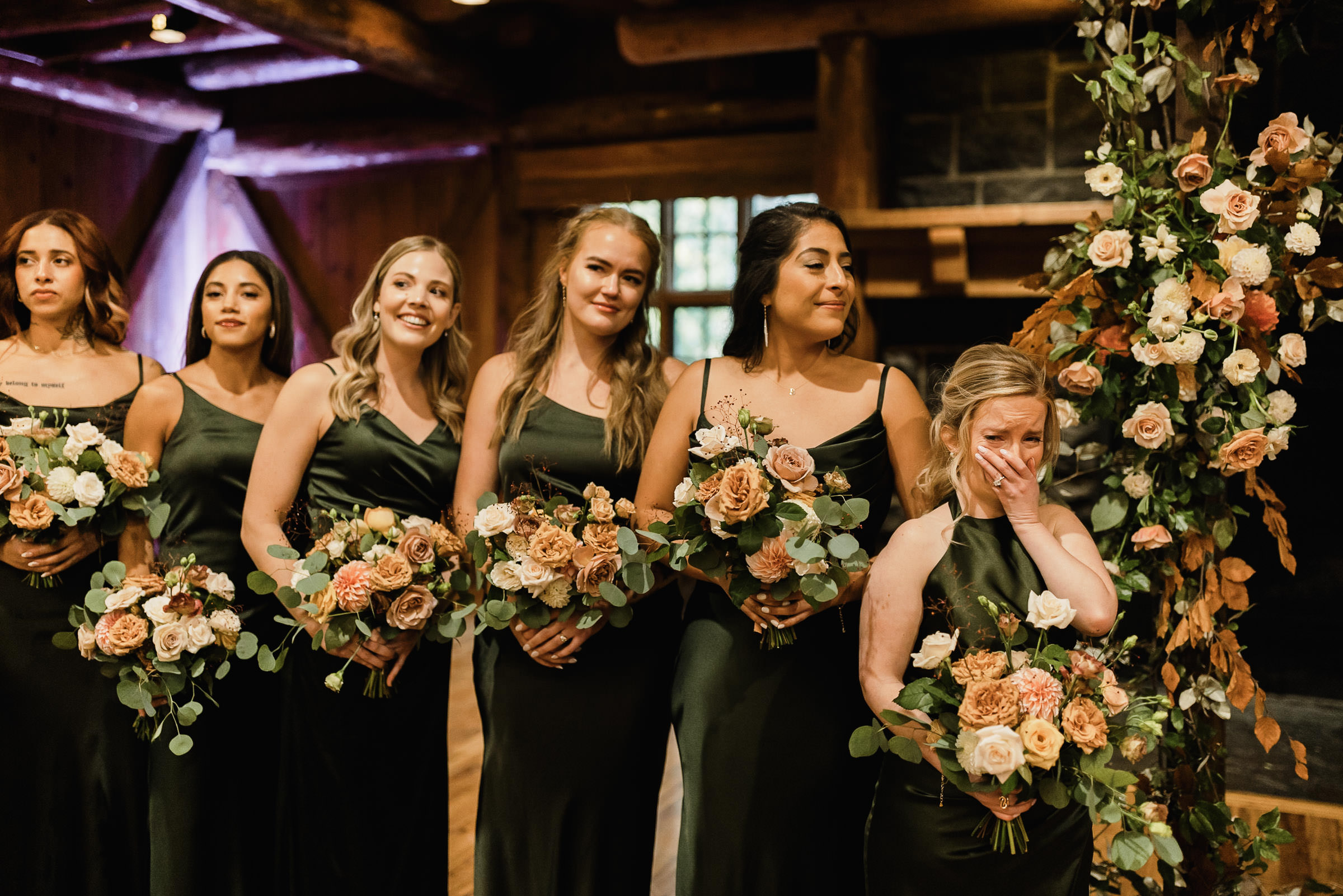 Bride's sister and maid of honor reacts emotionally as bride walks down the aisle